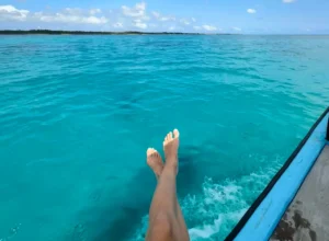 Woman in enjoying trip on the boat in crystal water, Zanzibar
