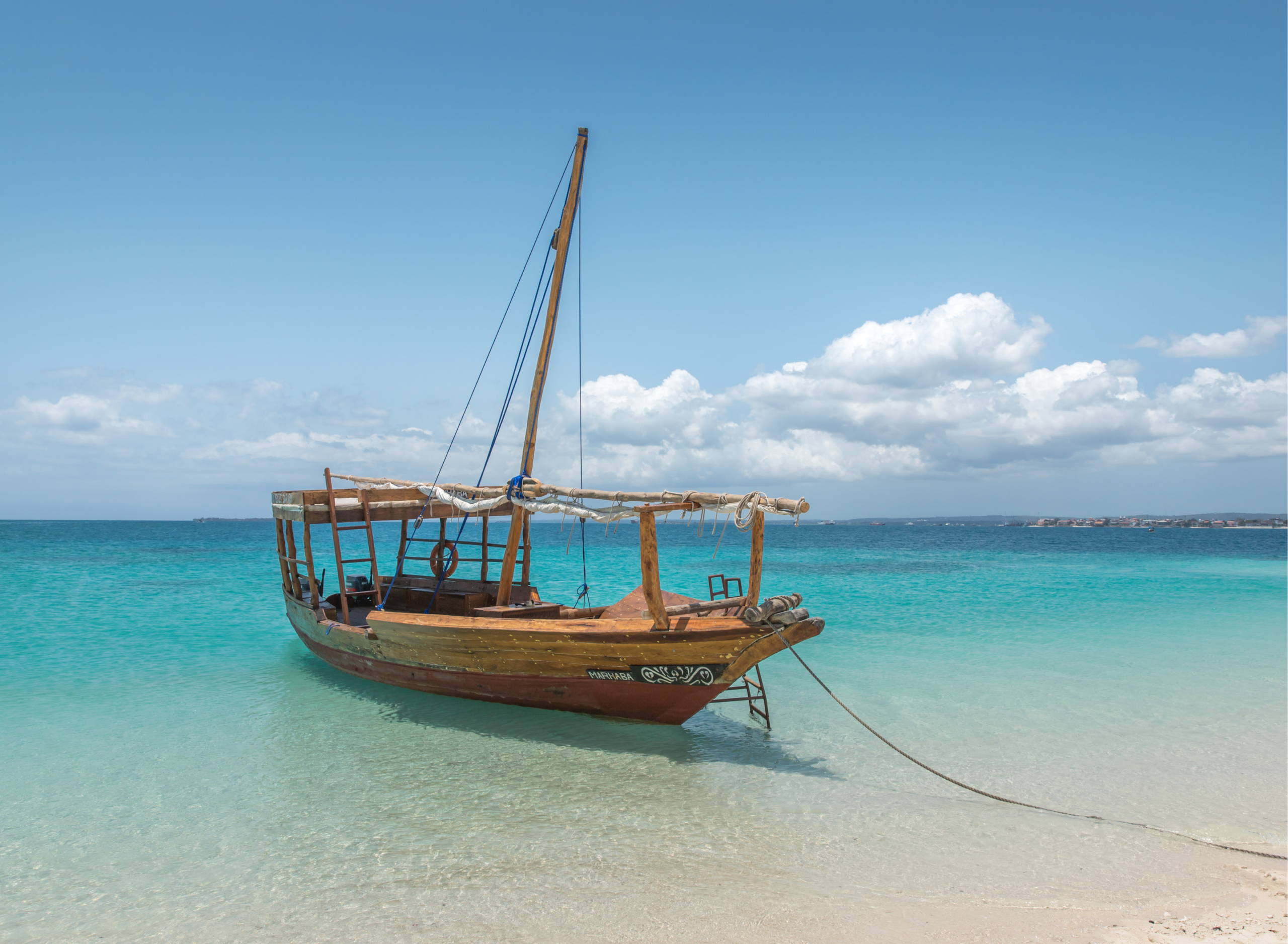 Traditional wooden dhow anchored near the beach in Zanzibar