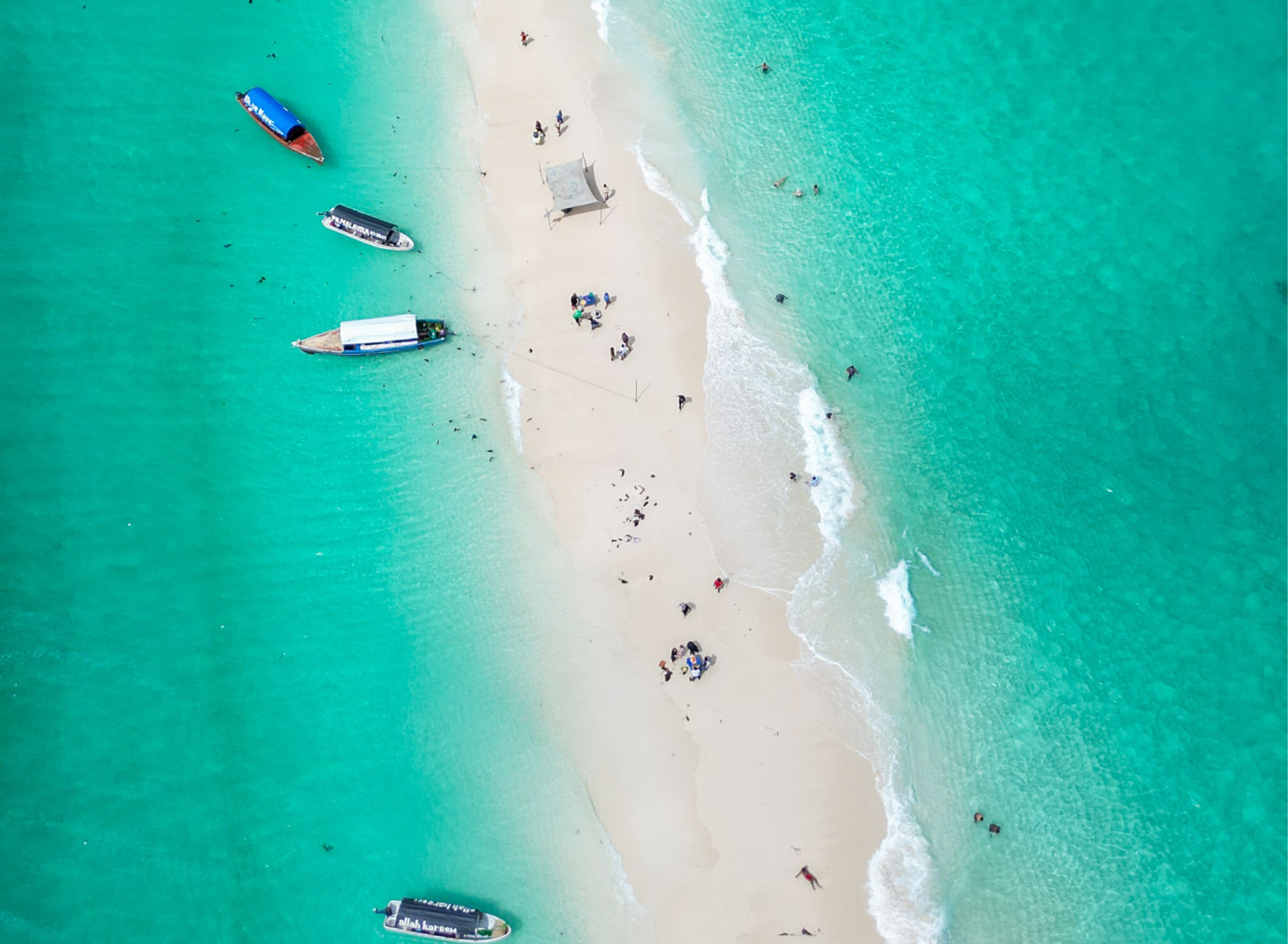 Aerial view of a white sandbank surrounded by turquoise water near Mnemba, Zanzibar